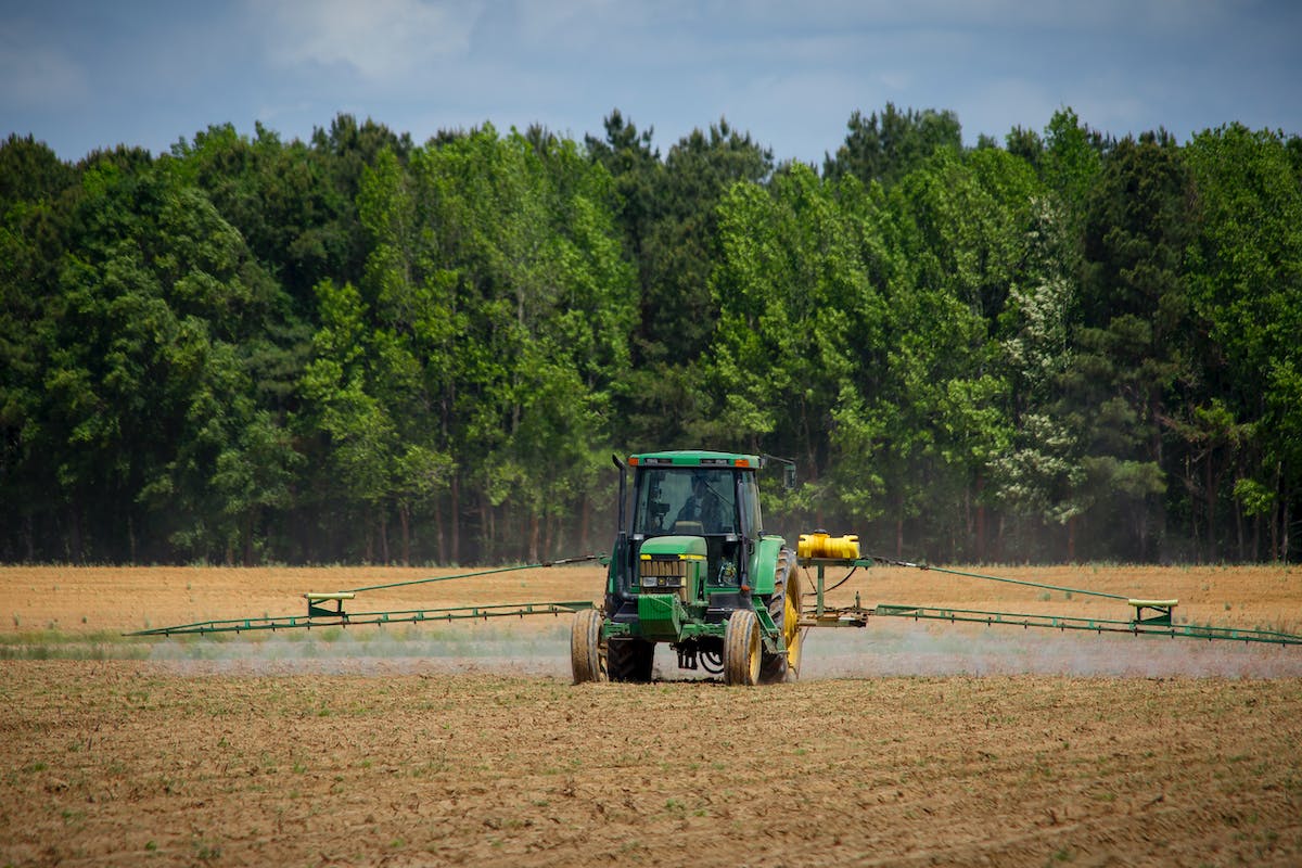 A tractor spraying something on a field